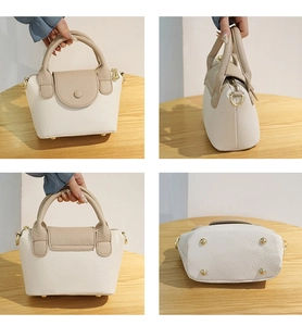 Macro-opname van de beige lederen tas met bodemklinknagels en goudkleurige hardware details