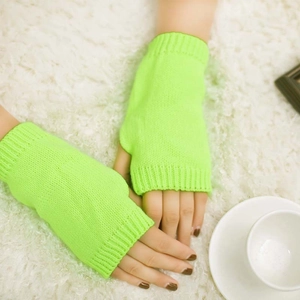 Detail view showing neon green knitted fingerless gloves with thick thermal wool texture