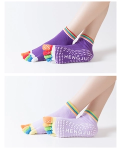Dettaglio di calze yoga antiscivolo con dita arcobaleno e grip in silicone bianco