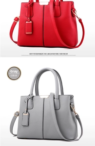 Detail of red and gray lychee pattern leather handbags with gold hardware and straps