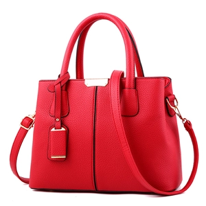 Chic red lychee pattern tote bag with dual handles and adjustable shoulder strap