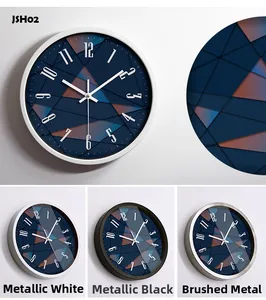 Detail of modern wall clock featuring navy geometric dial and three metal frame finishes
