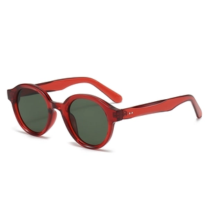 Retro oval red translucent sunglasses with dark lenses and stylish metal rivets decor