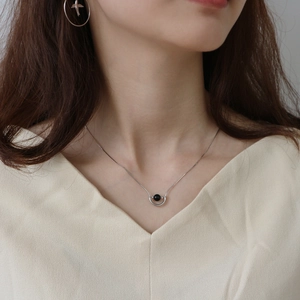 925 sterling silver necklace with U-shaped pendant and black onyx bead on model