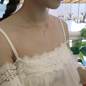 Minimalist 925 sterling silver airplane pendant necklace worn on a woman's collarbone