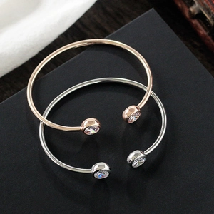 Adjustable zircon bangles in rose gold and silver finishes on a black background