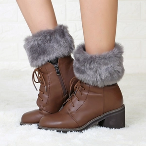 Detail of brown faux leather ankle boots with grey faux fur collar and side zipper