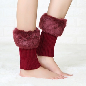 Detail of burgundy ribbed knit leg warmers with fluffy faux fur trim for winter