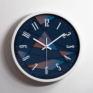 Modern round stainless steel wall clock with blue geometric dial and 12-hour analog display