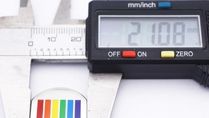 Macro shot showing the 21.08 mm width of the rainbow rectangle pendant using digital calipers
