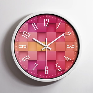 Minimalist stainless steel wall clock featuring a geometric pixel art dial design