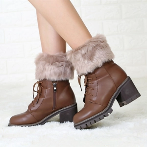 Close-up of brown platform ankle boots with plush faux fur trim and side zipper detail