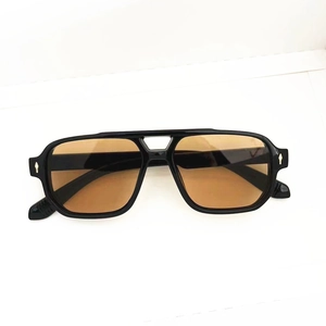 Macro shot of retro square sunglasses featuring double bridge and arrow rivets