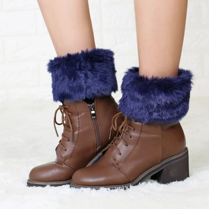 Close-up of brown lace-up boots featuring purple faux fur knit leg warmers for women