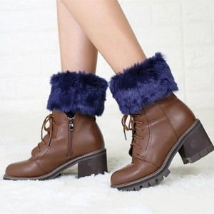 Detailed view of brown leather boots with purple faux fur trim and side zipper closure