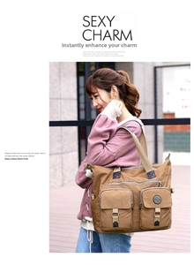 Detail view of khaki large capacity nylon tote bag with functional buckle pockets
