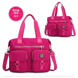 Close-up of fuchsia nylon bag showing reinforced handles and front zipper pockets