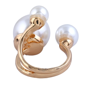 Detail of gold open ring featuring three asymmetrical white imitation pearls on white background