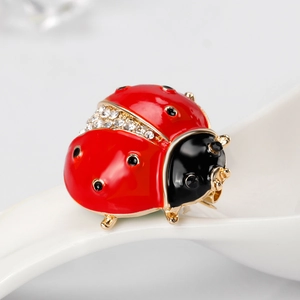 Sparkling ladybug brooch with red enamel and rhinestones on a gold alloy base