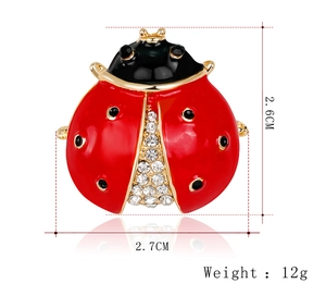 Detail view of ladybug brooch showing 2.6cm x 2.7cm size and rhinestone enamel finish