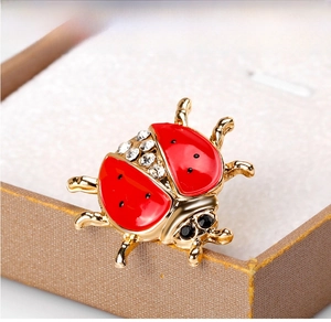 Detailed macro view of the alloy ladybug brooch with crystals and red enamel finish