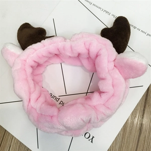 Close-up of pink plush deer antler headband with soft fabric texture for facial skincare