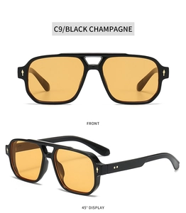 Double bridge square sunglasses with black frame, champagne lenses, and silver rivet detail