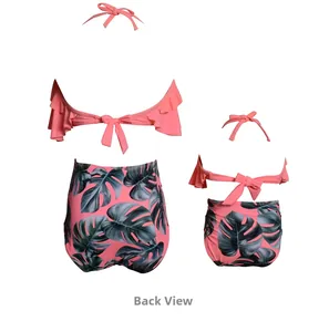 Back view of pink ruffled bikini top and tropical leaf print high waist bottoms