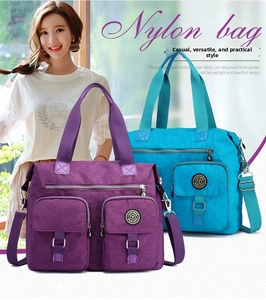 Detail of multi-pocket waterproof nylon travel tote bag in purple and sky blue