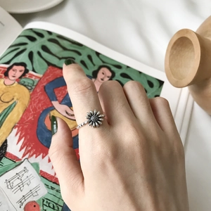 Retro S925 sterling silver daisy open ring with oxidized finish on vintage book page