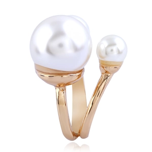 Detailed macro view of the gold adjustable ring with dual white faux pearls