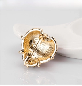 Detailed back view of golden ladybug brooch showing secure safety pin and metal texture