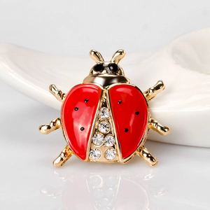 Cartoon ladybug brooch with red enamel and sparkling rhinestones in gold finish