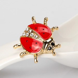 Cute ladybug brooch with red enamel wings and sparkling rhinestones on golden alloy base
