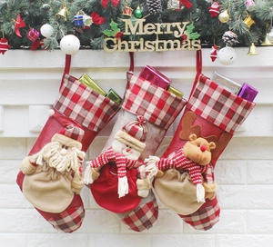 Hanging Christmas stockings with Santa, Snowman and Reindeer on a festive white fireplace