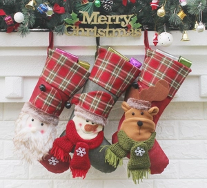 Three premium 3D character Christmas stockings hanging on a fireplace mantel