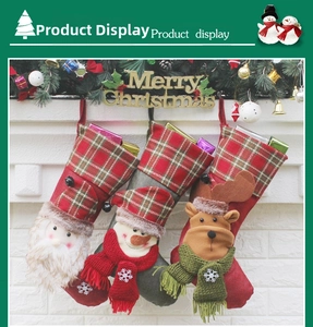 Three festive Christmas stockings with Santa, snowman and reindeer hanging on a white mantel