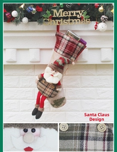 Detail of burlap Santa Claus Christmas stocking with red plaid accents and 3D doll