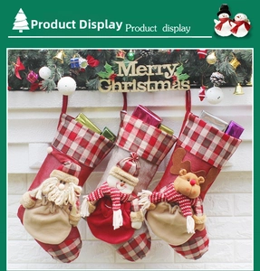 Detail of Christmas stockings with 3D Santa, Snowman and Reindeer hanging on a wall