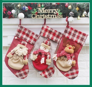 Three festive Christmas stockings with Santa, snowman and reindeer on a white mantel