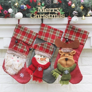 Set of 3 luxury knit Christmas stockings with Santa, Snowman and Reindeer on a fireplace