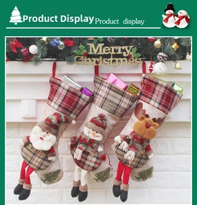 Detail showing set of 3 Christmas stockings with Santa, Snowman and Reindeer on brick wall