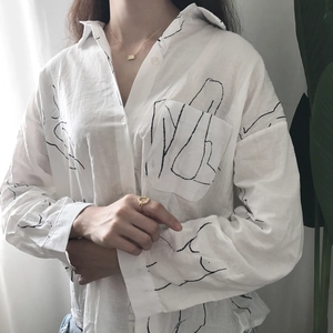 Close-up of minimalist white cotton shirt with black artistic line print and front pocket