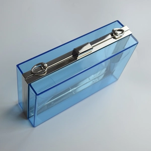 Detailed top view of transparent blue acrylic evening clutch with silver metal hardware