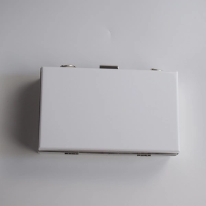 Top view of white acrylic clutch bag with silver metal clasps and chain hooks