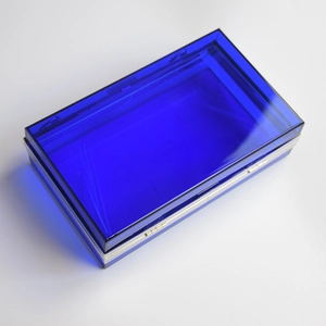 Detail view of cobalt blue acrylic evening clutch with silver metal clasp and hinges
