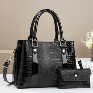 Women's black crocodile pattern handbag set with crossbody strap and gold hardware