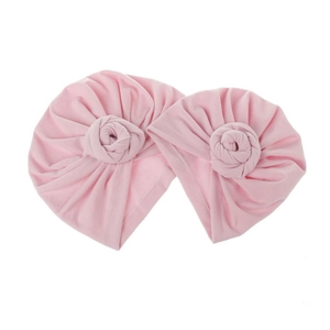 Pink knotted infant turban hats for babies featuring a decorative 3D rose donut knot