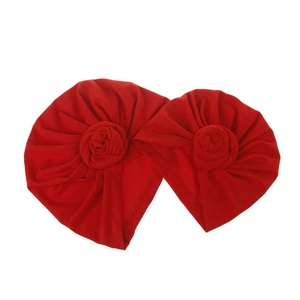 Set of red knotted baby turbans featuring twisted rose knot decoration in elastic knit fabric