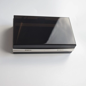 Macro view of a black acrylic evening clutch bag with sleek silver metal trim detailing